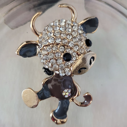 Cute cow made of metal with rhinestone head