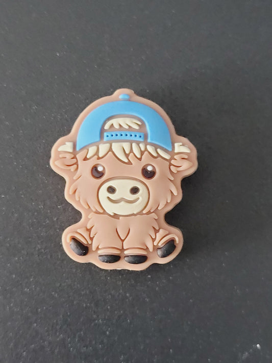 Focal cow with blue backward baseball hat bead