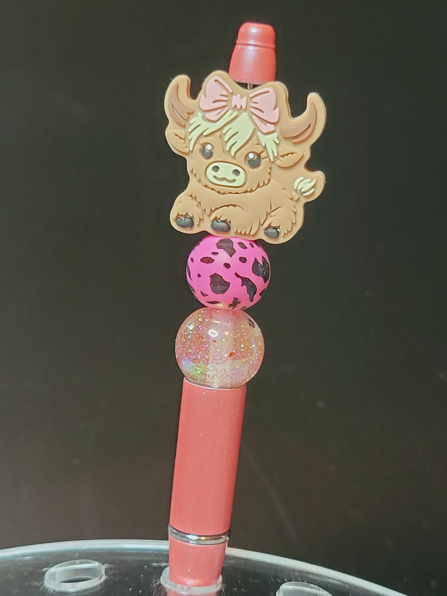 Pen girl cow wearing pink bow